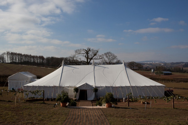 Exterior of a traditional canvas marquee installed for a spring wedding in the Shropshire hills