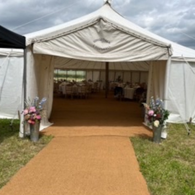 Traditional wedding marquee entrance with coir matting walkway